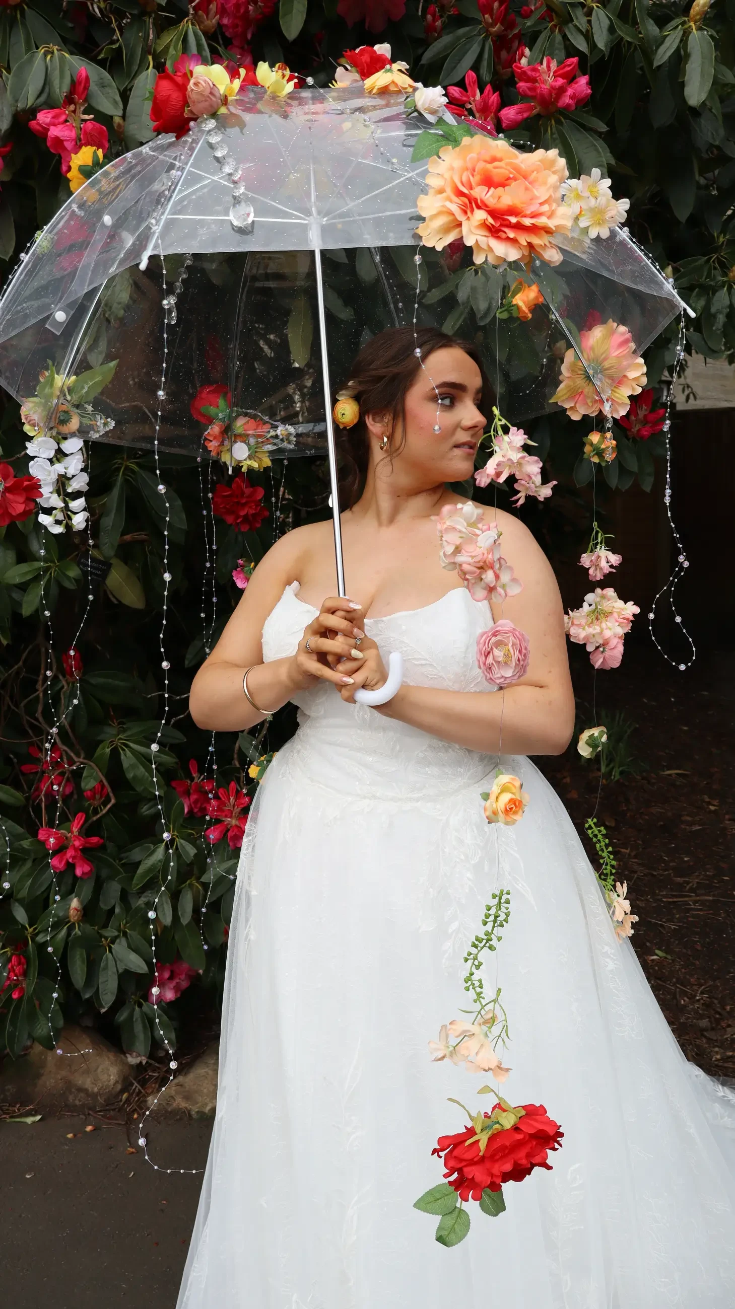 model wearing a bridal gown and holding an umbrella